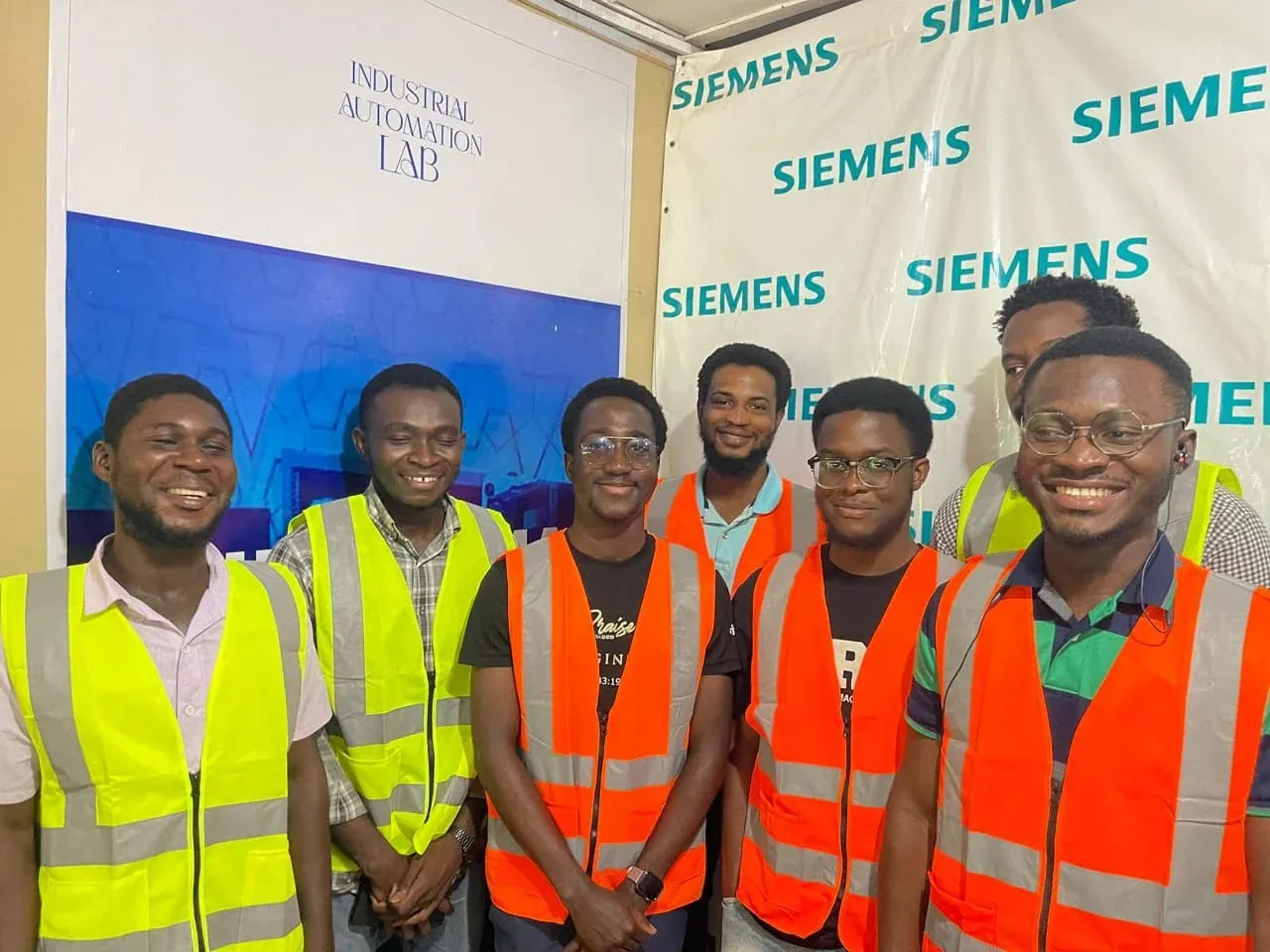Group of trainees in hi-vis vests at an industrial automation lab