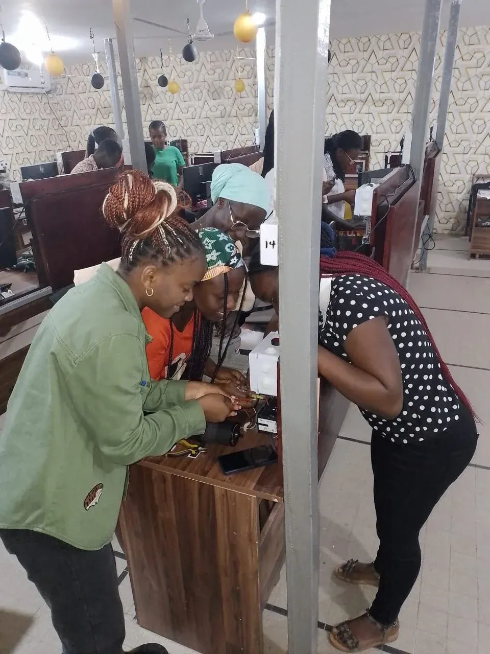 Trainees wiring components at lab workstations